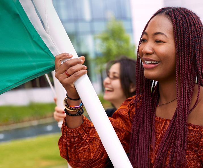 Apple Cork employee walking and holding a flag.
