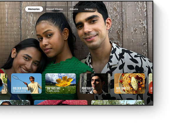 Photos app on TV screen, Memories tab selected, four people smiling, row of dated memory thumbnails below