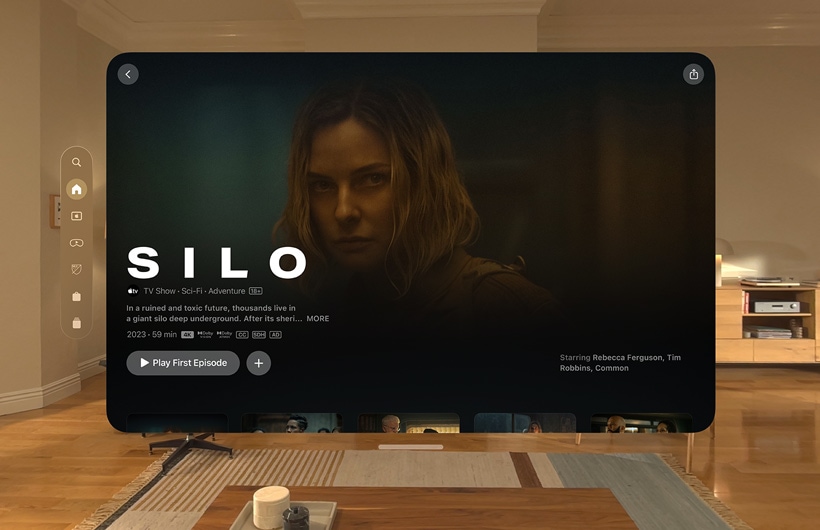 The Apple TV experience of Apple Vision Pro is displayed in a living room, with a still image from the Apple TV series Chief of War