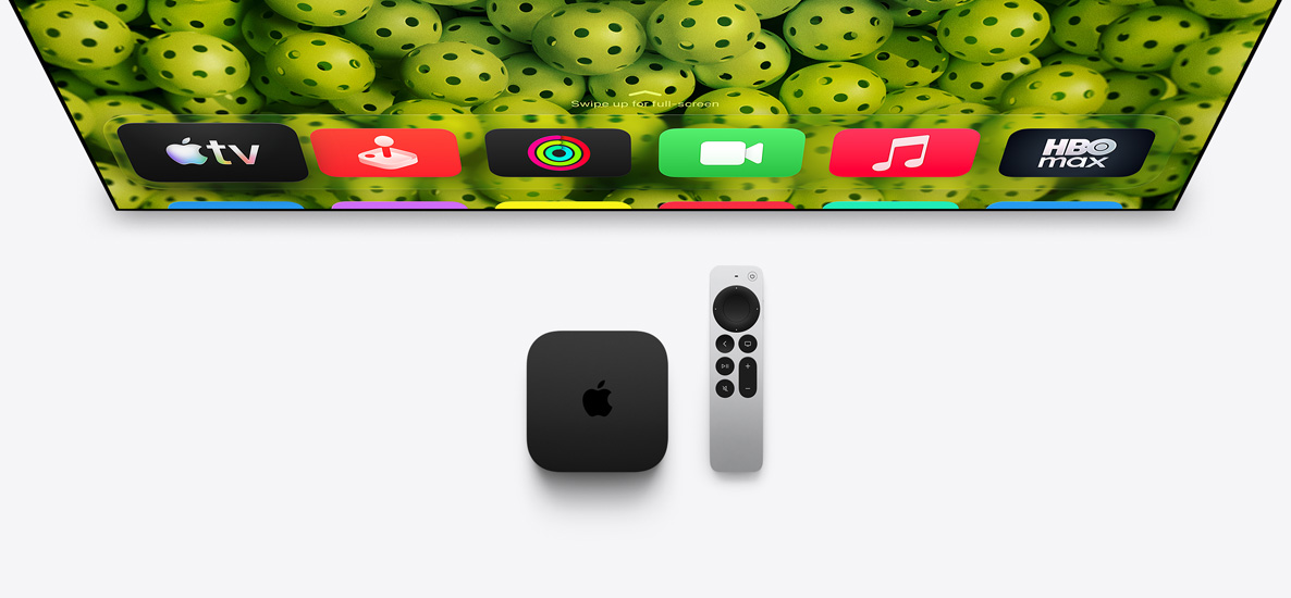 Apple TV 4K and Siri Remote below TV screen, screen shows Home Screen top row app icons over a green pickleball background