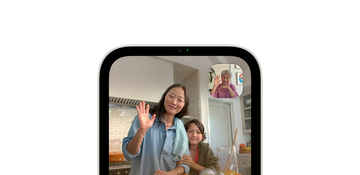 Apple HomeView, screen shows a FaceTime video call with a woman and child in a kitchen, and an older woman waving in the inset window