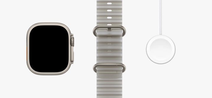 Apple Watch Ultra 4, dabīga titāna krāsas ietvars, pilnekrāna displejs, puscaurspīdīgi pelēka Ocean Band siksniņa, Apple Watch magnētiskais ātrās uzlādes USB-C kabelis