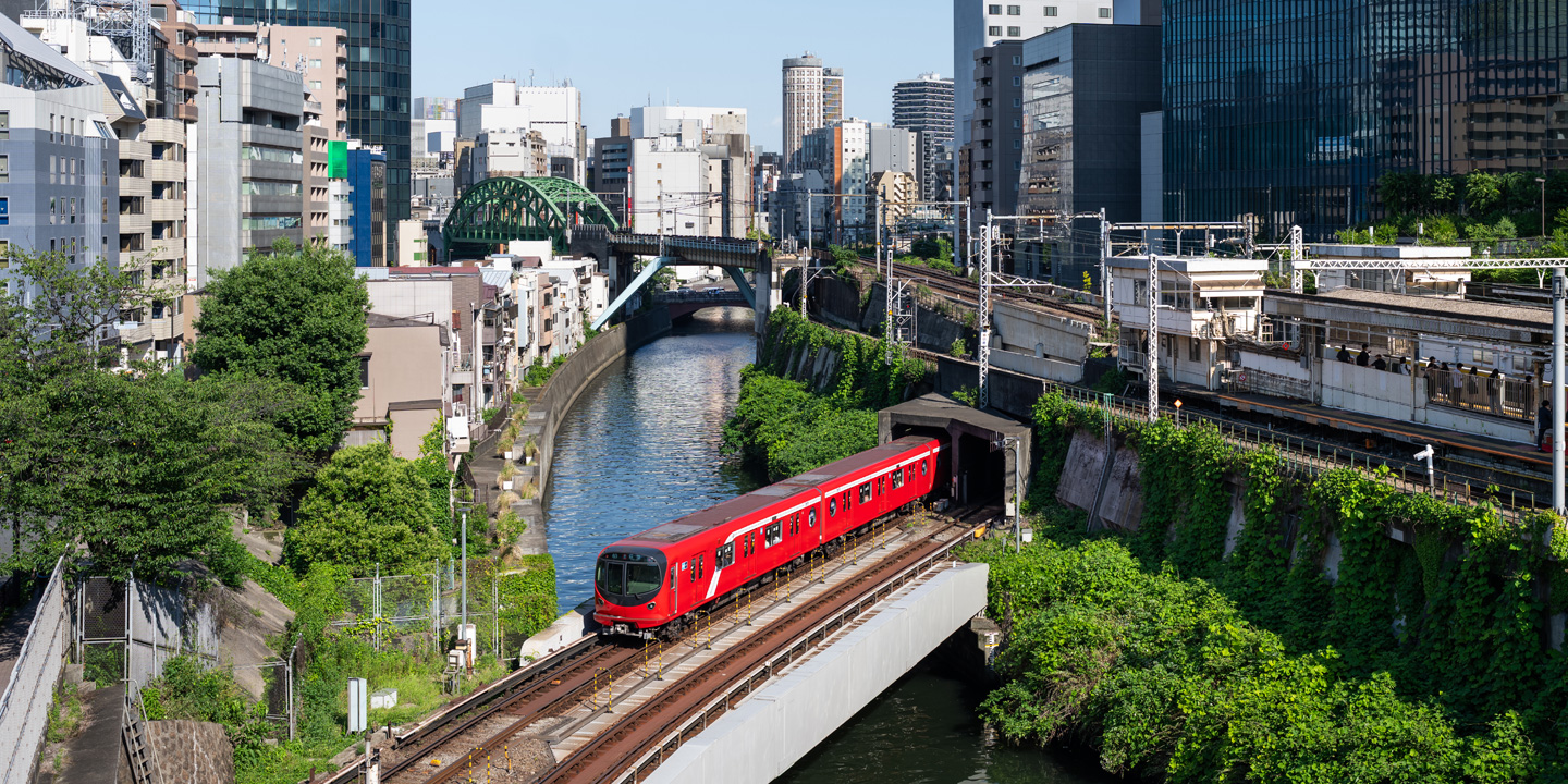 Glimpses of Tokyo Metro, including trains crossing bridges, daily operations, and maintenance work.