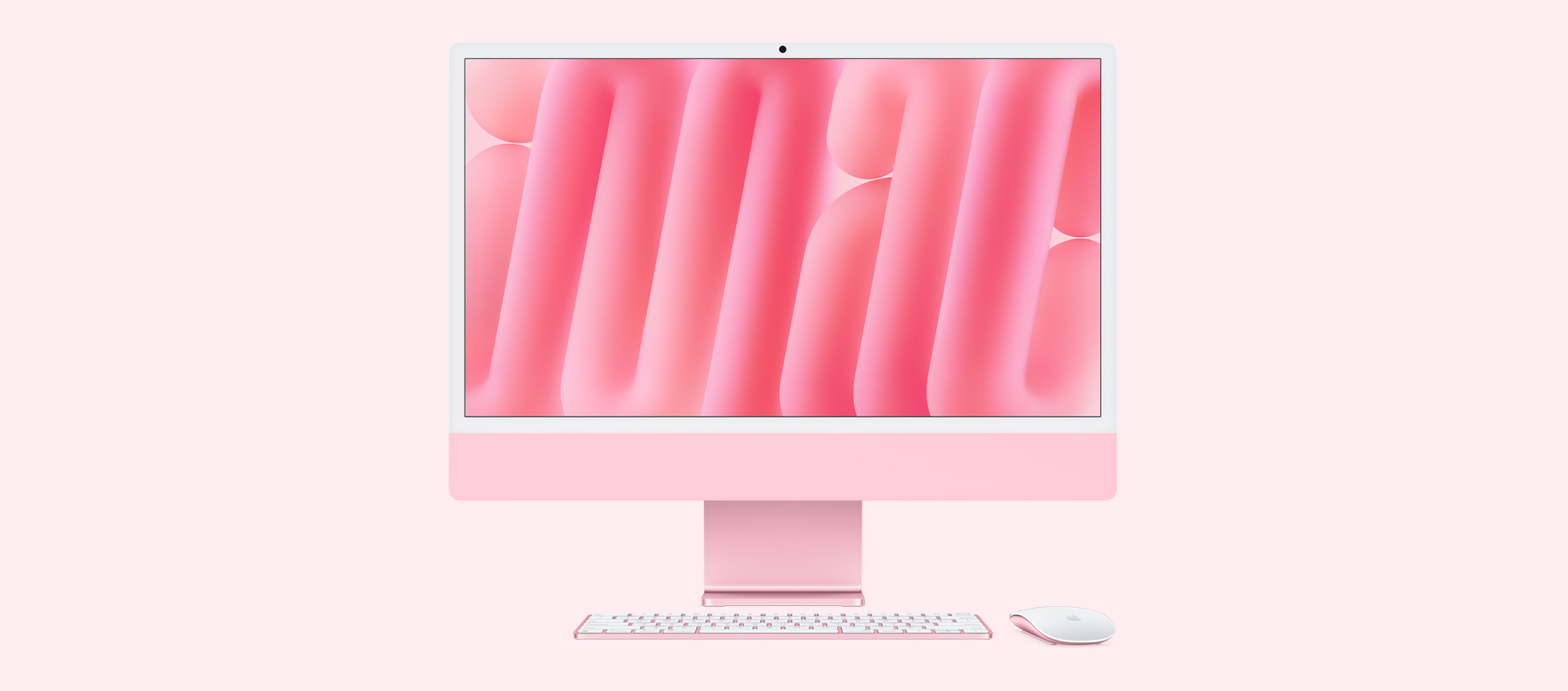 Front view of a pink iMac with colour-matching mouse and keyboard